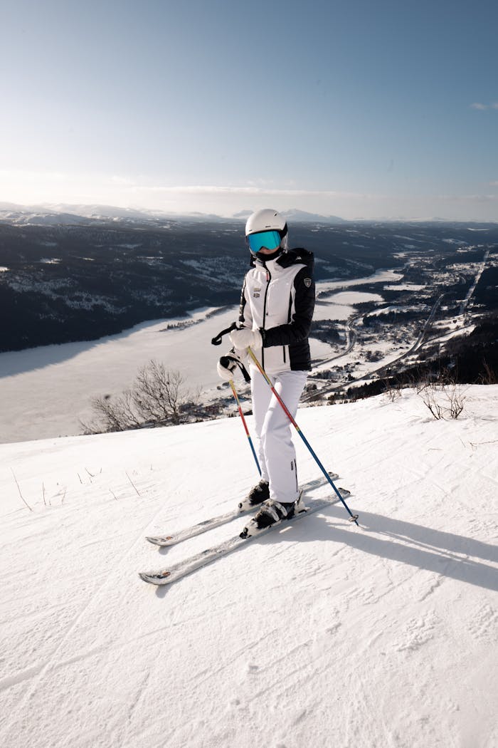 Ski enthusiast enjoying a bright winter day on a snow-covered mountain slope.